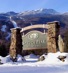 Spruce Peak at Stowe Sign with snow covered Mt. Mansfield in the background